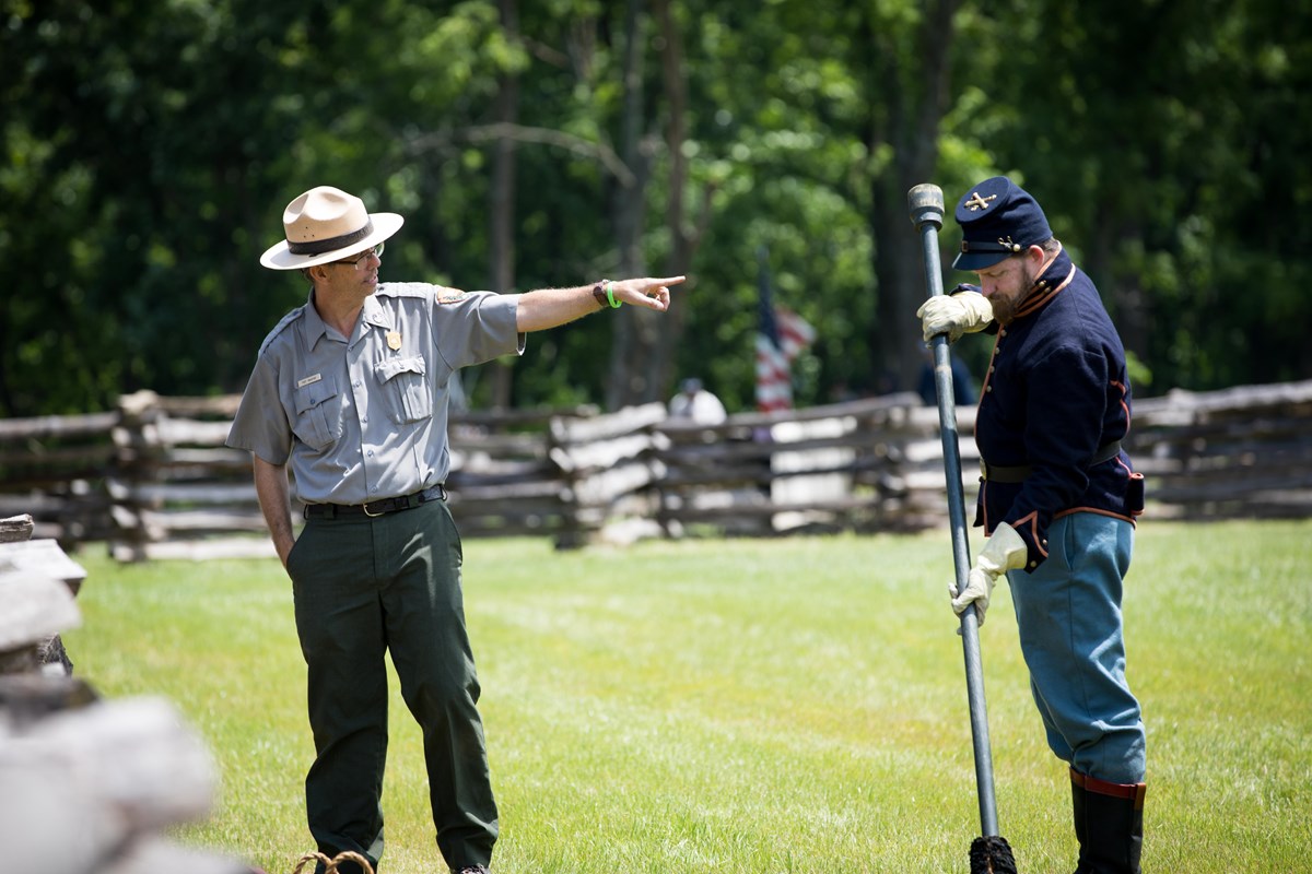 Photo of Park Ranger talking about cannon and Cannon Crew. 