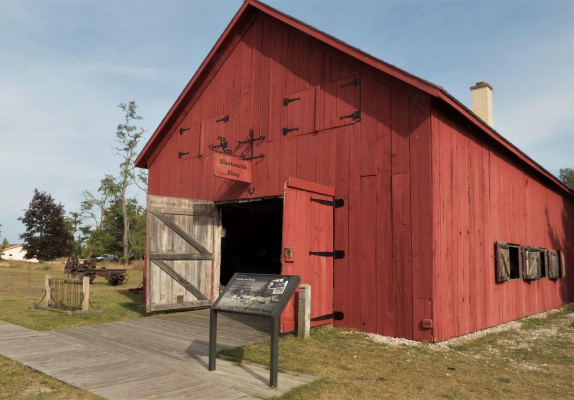 A red barn-like building with two open doors