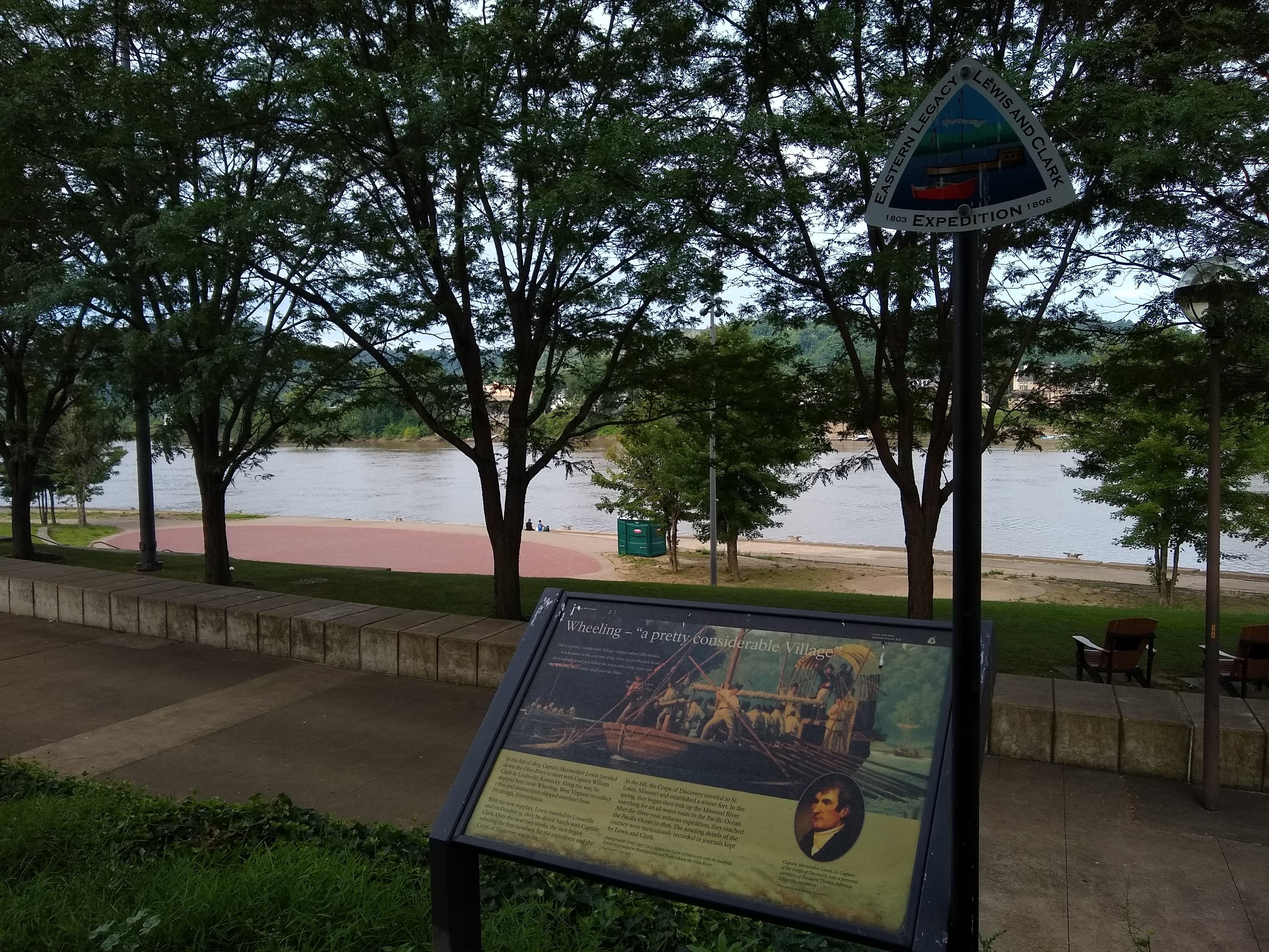 Interpretive sign overlooking park and river in the background