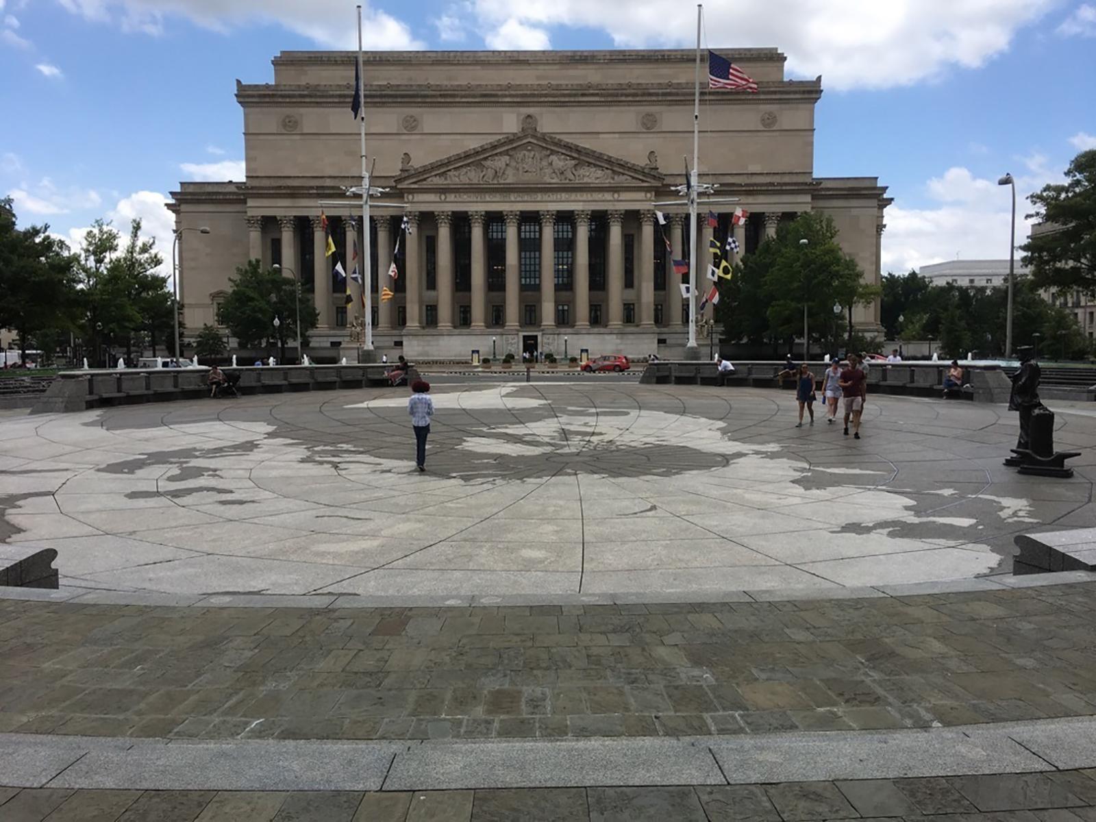 A stone plaza depicting a map of the globe.