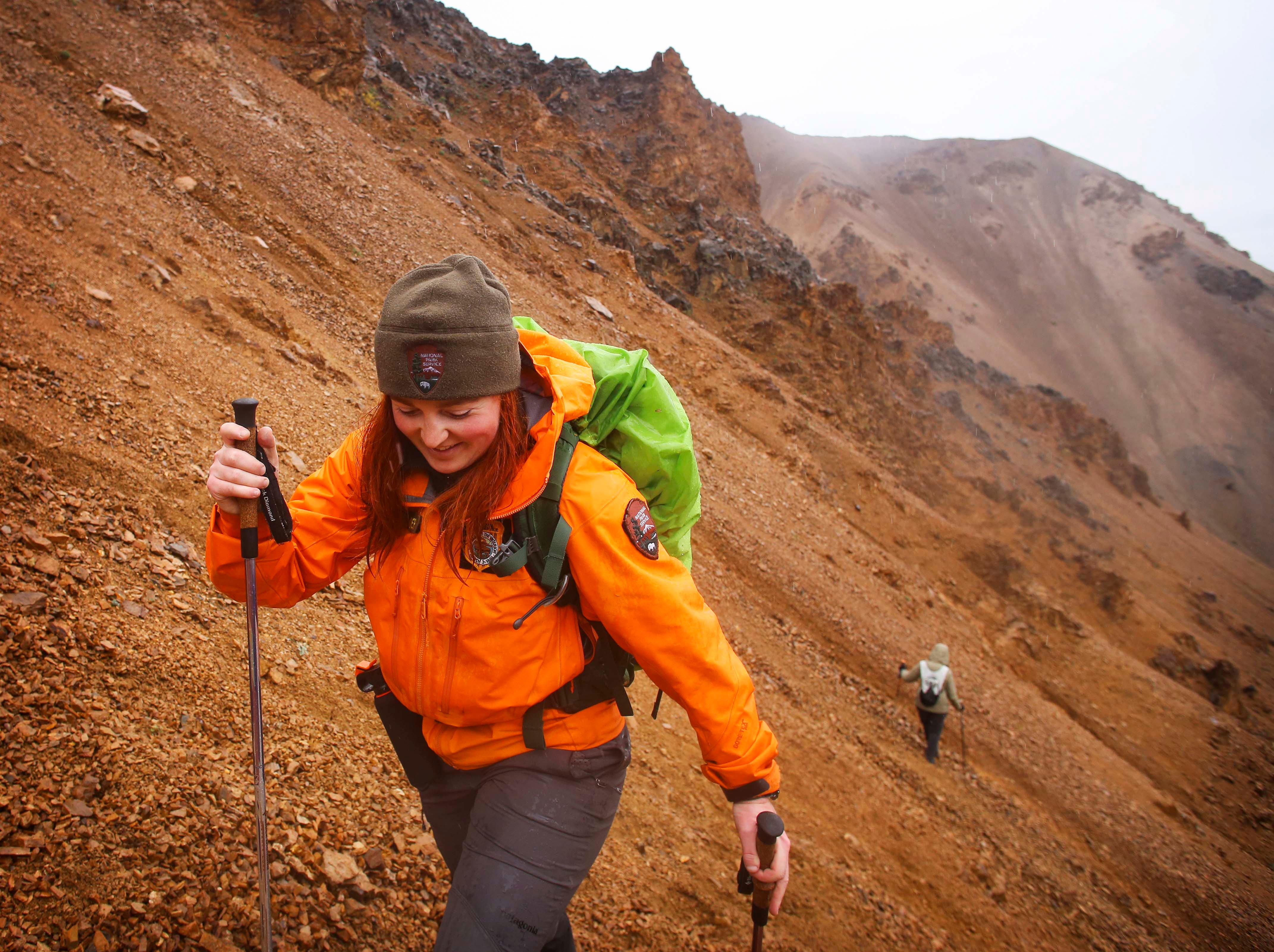 a park ranger leading hikers up a steep mountainside