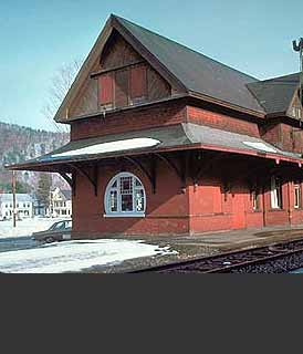 This is an image of a small freestanding railroad station. Clad in wood, it has a steep gable roof, lower pent roof, and arched window as well as other windows that are less prominent. The image rolls over to provide the correct answer. Screen Reader users see text-only link, left, for answer. Photo: NPS files.