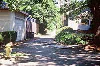 This is an image of a shaded alley way with garages. Photo: Oregon State Historic Preservation Office.