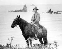This is an image of Oswald West on horseback at Cannon Beach, ca. 1913. Photo: Courtest, Harriet Drake.