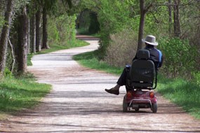 CVNP visitor rides an electric wheelchair along Towpath north of Ira Road.