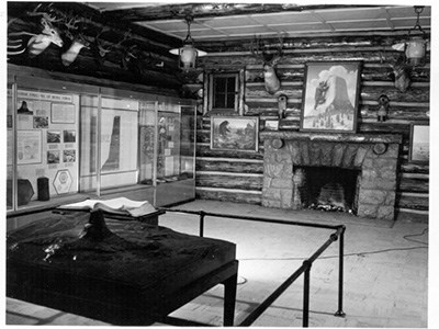 The inside of a log structure with various exhibits and artifacts