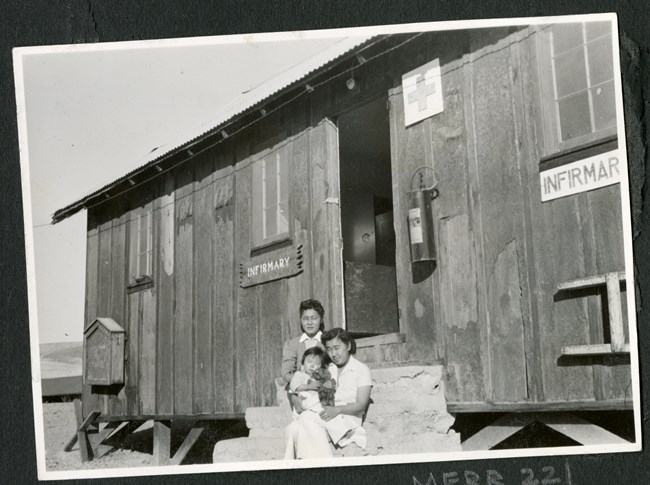Women and children on the steps of a makeshift infirmary. Women and children on the steps of a makeshift infirmary.
