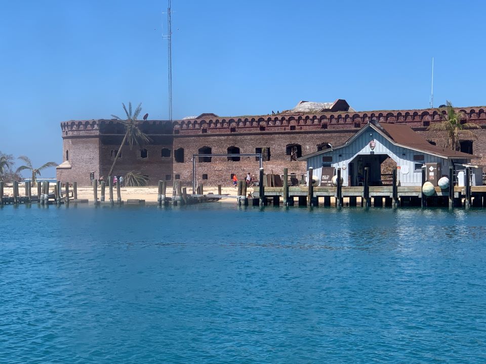 Dock in front of a brick fort taken from the water