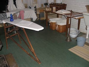 Laundry room with green 1950s -1960s linoleum.