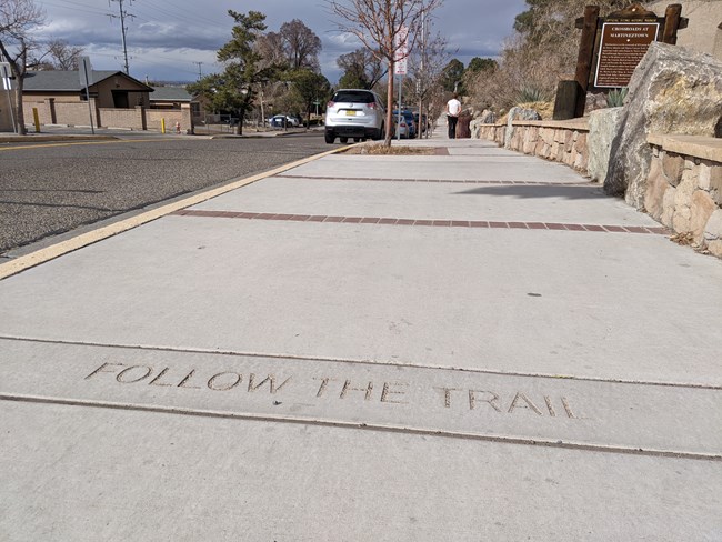 Follow the Trail written in the sidewalk