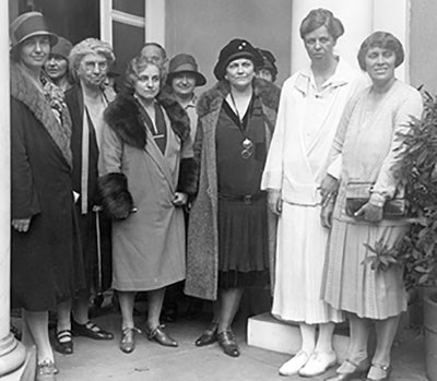 A group of women standing outside of a building.