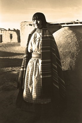 black and white picture of a woman wearing traditional clothing from Mexico