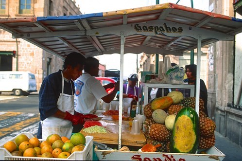 fruit stand with people selling fruits