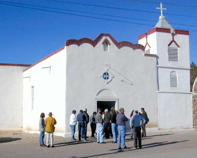 people entering a white church