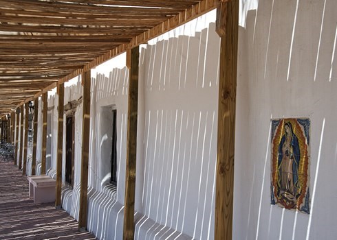 hall of a white building with wooden ceiling and an image of virgin mary