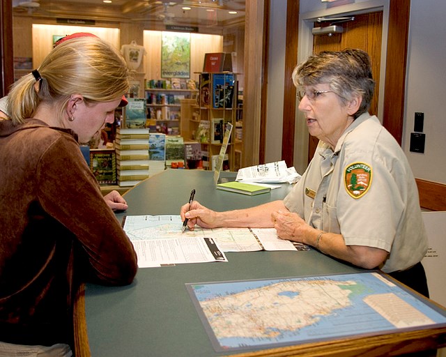 Volunteer and visitor looking at a park map