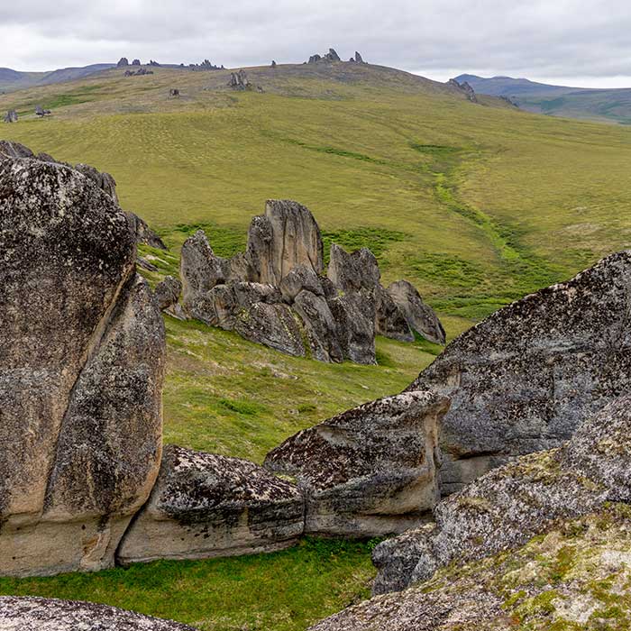 In this photo, Giant granite rocks rise from the surrounding rolling hills.