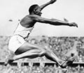 Jesse Owens, mid air, during his victorious long jump at the Berlin Olympics.