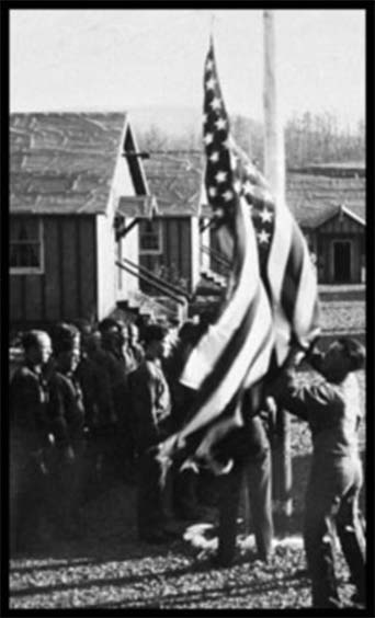 Men raising the flag at camp.