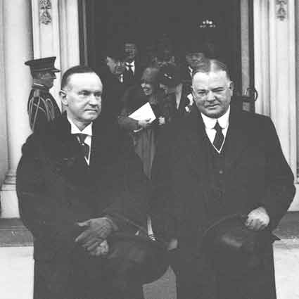 Coolidge standing with Hoover outside.