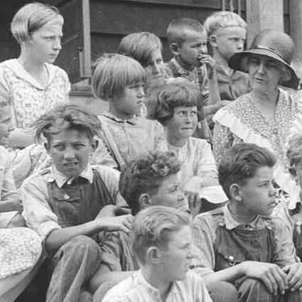 Children gathered on the steps of the Mountain School with Lou Henry Hoover.