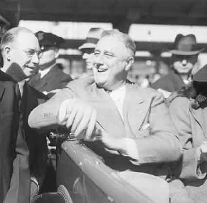 Franklin Roosevelt riding in an automobile.