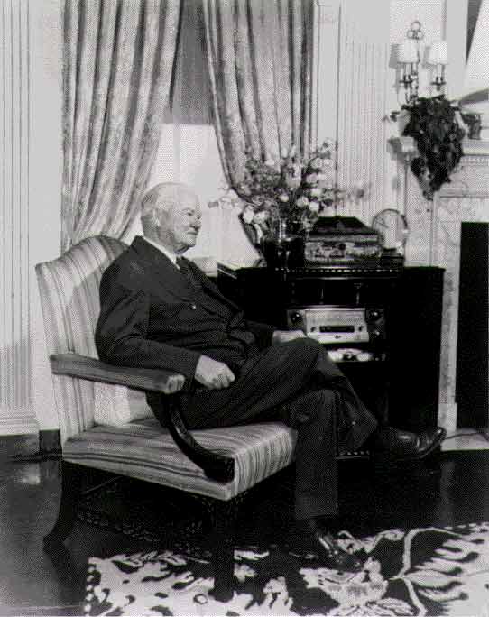 Elderly Herbert Hoover sitting in a chair.