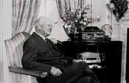 Elderly Herbert Hoover sitting in a chair.