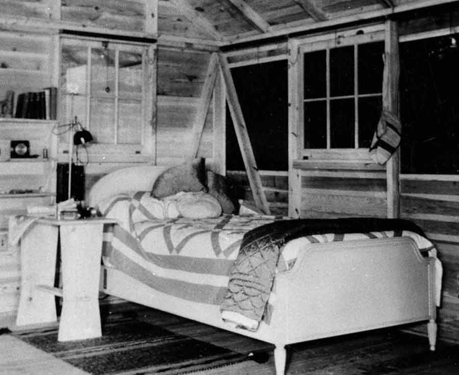 The bedroom, containing a twin bed and night stand.