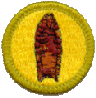circle with yellow background and brown arrowhead