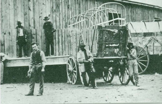 Conestoga wagon at a loading dock.