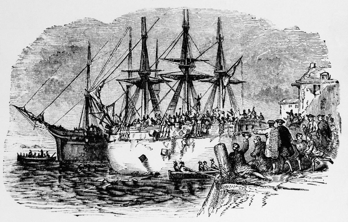 An old wooden ship with three masts. Hundreds of men crowd around and on it tossing large bundles into the water. 