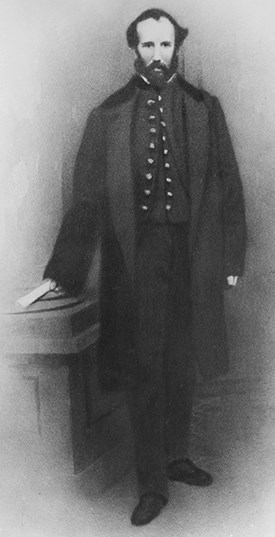 Captain William Shoemaker standing, wearing open frock coat and vest.