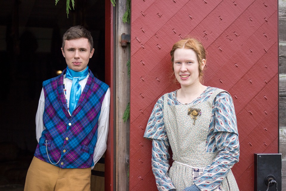 Young man and woman in period costume dress