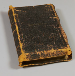 A worn leather bible with "Frederick Douglass" embossed on the cover.