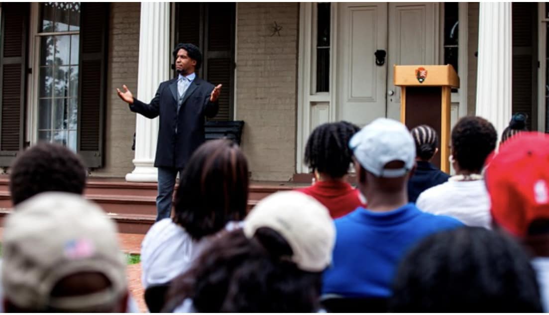 Frederick Douglass actor doing a dramatic reading to visitors at Cedar Hill