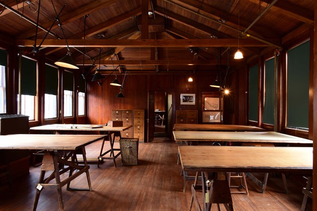 Four wooden tables in room