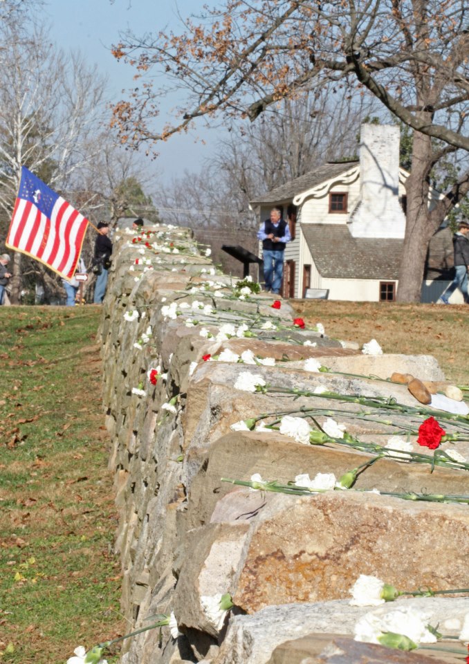 Red and white carnations lie a top the Stone Wall along the Sunken Road at Fredericksburg.