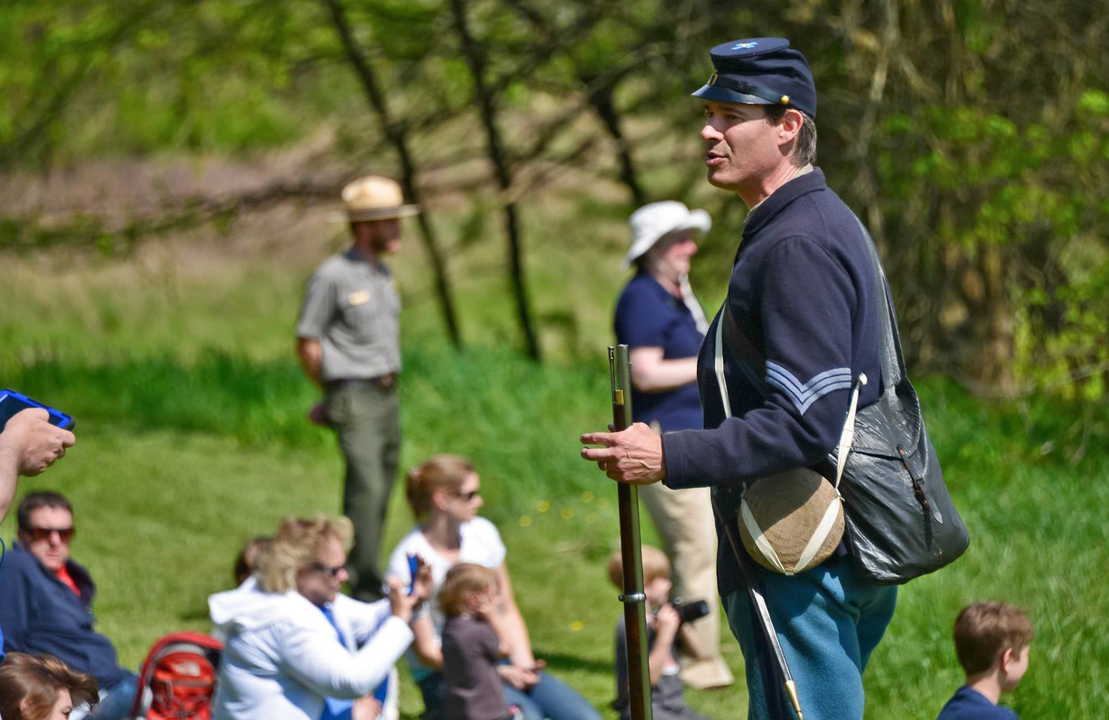 A living historian in US Civil War soldier uniform speaks to the public.