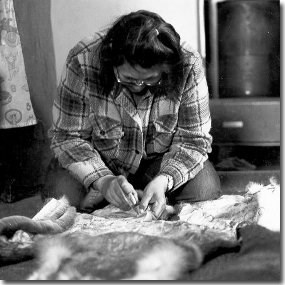 Nunamiut woman working with caribou hide
