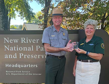 Volunteer receiving an award from the Park Superintendent