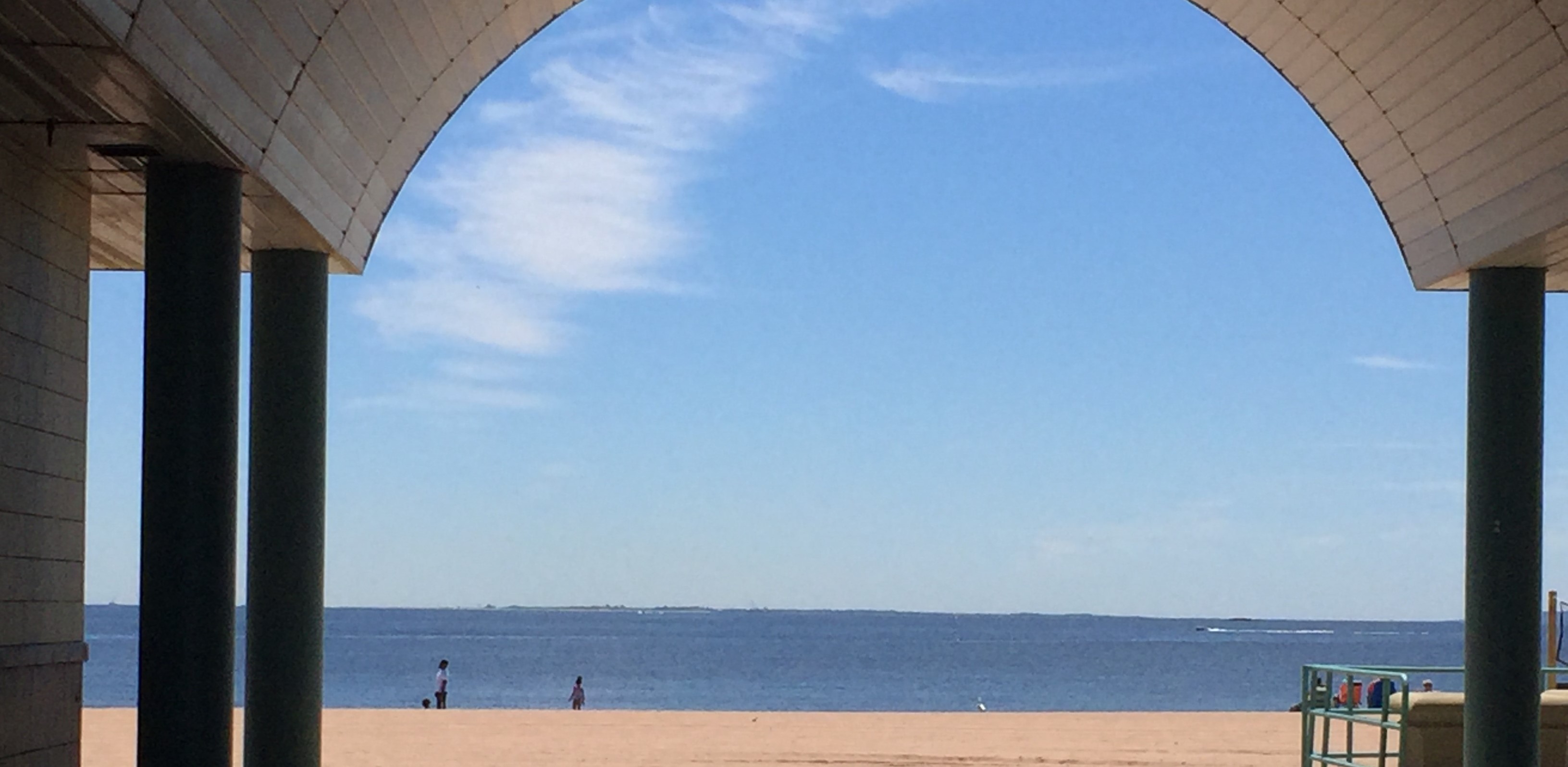 Beach seen through arched entrance of building