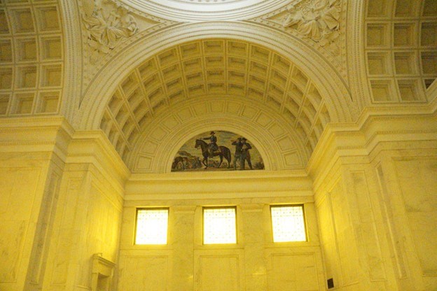 The interior of Grant's Tomb illuminated by golden light