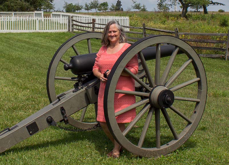 Winona Peterson standing next to a cannon.