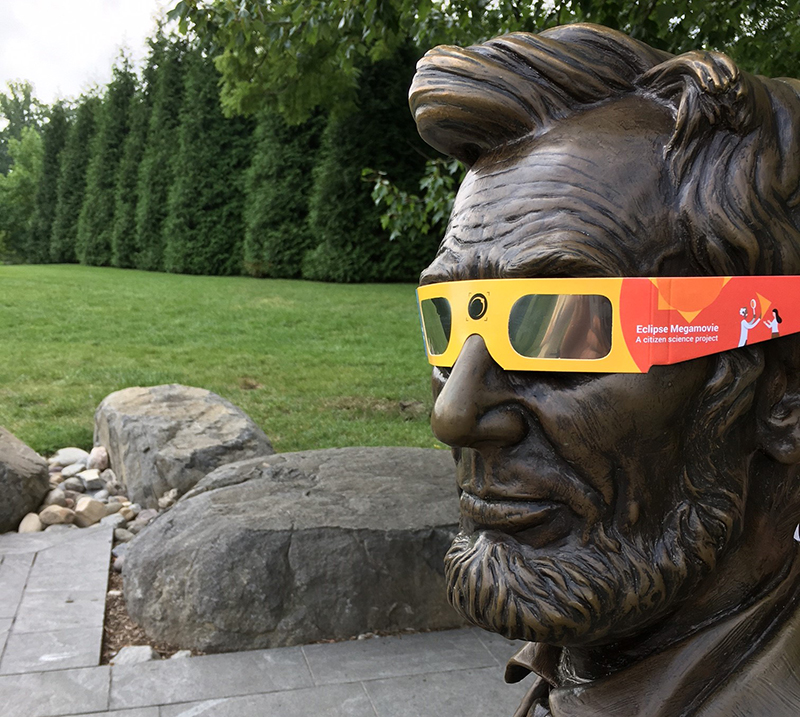 Abraham Lincoln statue wearing eclipse glasses