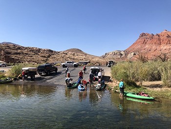launch ramp busy with fishing boats and kayaks