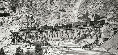 Picture of Transcontinental Railroad Bridge with train constructed in the Wasatch Mountains of Utah. Photograph by Andrew J. Russell, 1869