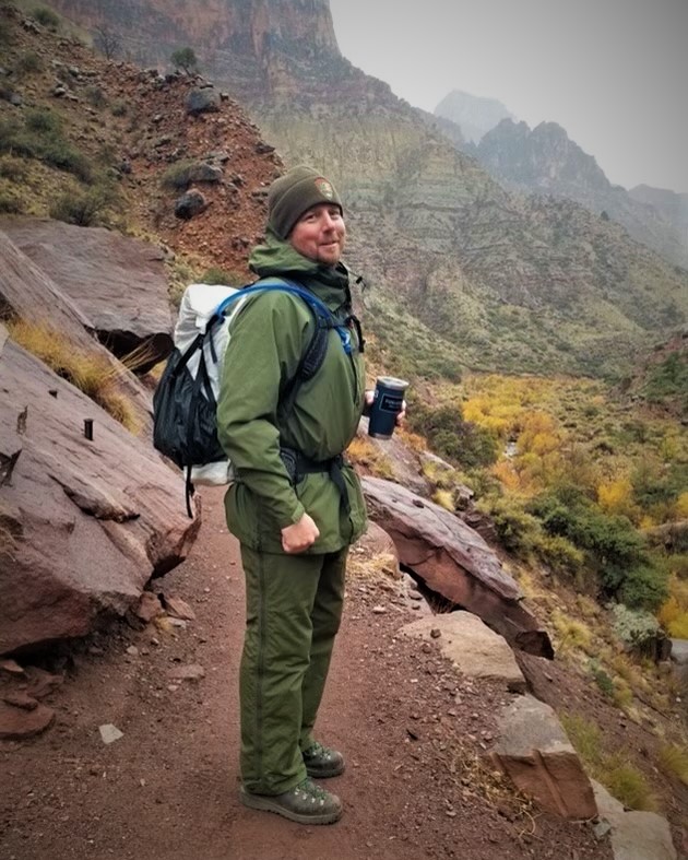 Matthew Snider Matthew Snider is wearing an NPS green uniform and hiking on a remote backcountry trail in Grand Canyon.