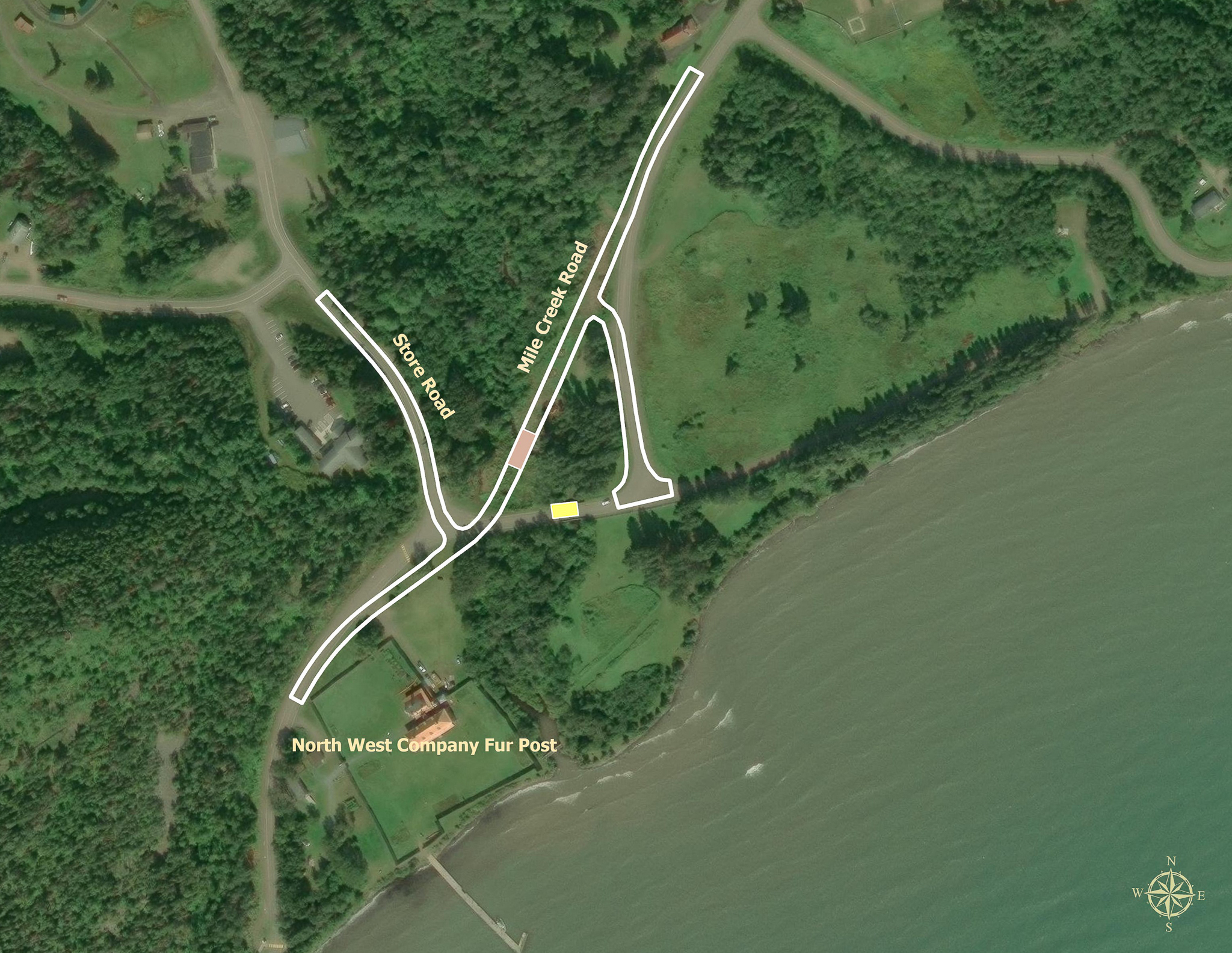 Satellite imagery of Mile Creek Road and Store Road junction near the North West Company Fur Post. White outlines overlay the satellite image demonstrating location of the realignment of Mile Creek Road and the location of the new bridge.