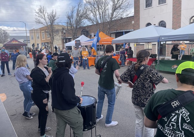 A busy downtown event in Alamosa with booths and live music